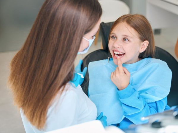 Girl Smiling After Dental Emergency Is Resolved